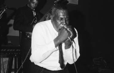mid 1960s, Detroit, Michigan, USA --- Born Chester Arthur Burnett, (named after the president,) bluesman Howlin' Wolf rocks the house in Detroit. --- Image by © Michael Ochs Archives/Corbis